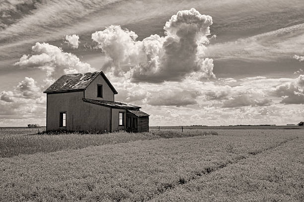 istock Abandoned House on the Prairies with Clouds in Background 577322828