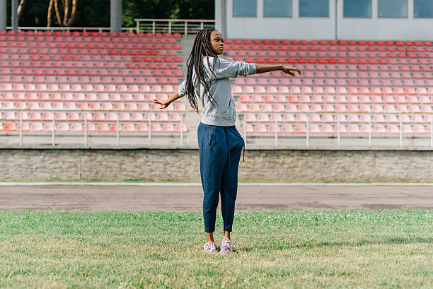 istock Young attractive African American female working out outdoors at a 577322946