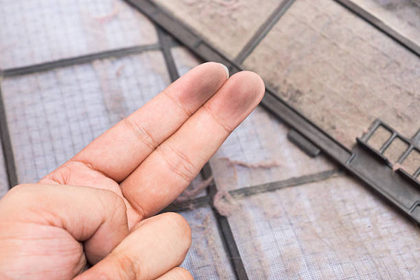 istock dirty air conditioner filter and dirty finger 577326664