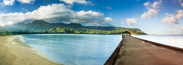 Widescreen panorama of Hanalei Bay and Pier on Kauai Hawaii High definition stitched panorama of Hanalei Bay and pier at dawn with the Na Pali coast in the background near Hanalei, Kauai, Hawaii hanalei bay stock pictures, royalty-free photos & images