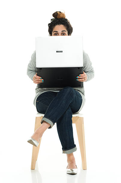 istock Woman hiding behind laptop 577329984