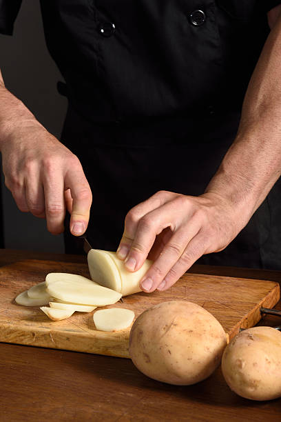istock detallle of a chef slicing potatoes 577331164