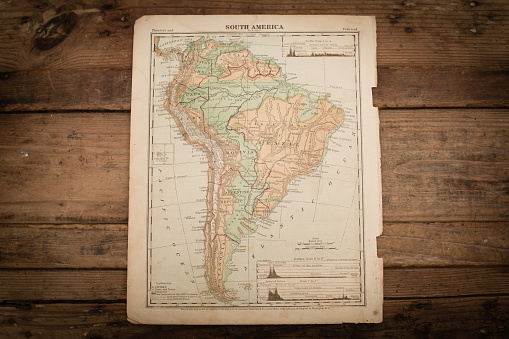 Color stock photo of an antique South America map illustration page on an old, wooden trunk. Salvaged from an 1871 geography book.