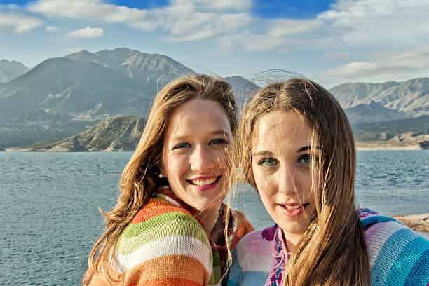 istock Two beautiful teens enjoy outdoor 577334514