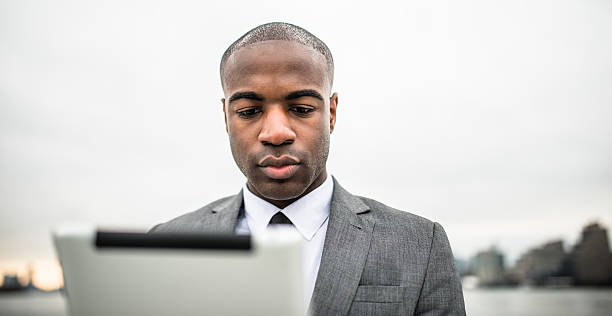 istock Businessman with tablet on the city 577335870