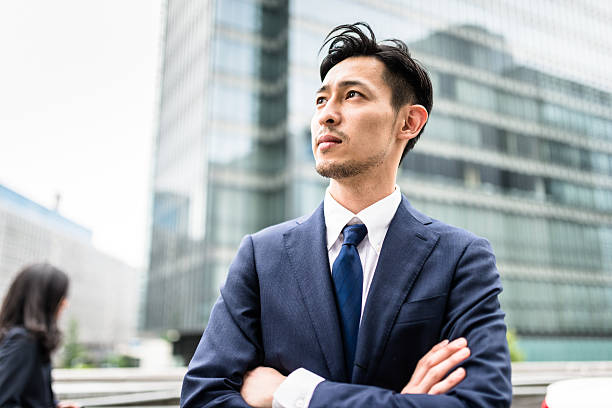 Business japanese standing with arm crossed