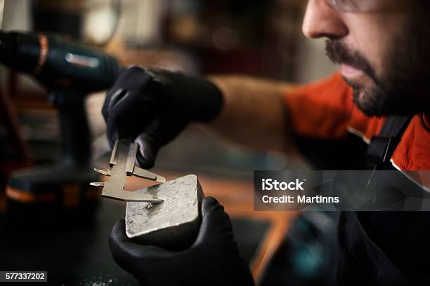 Young Craftsman Machine Piece And Repairing Stock Photo - Download Image Now - 2016, Adjusting, Adult