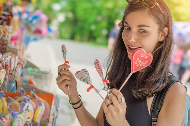 istock Smiling beautiful young woman with lollipops 577337268