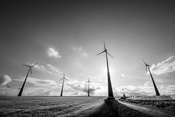 AERIAL: Wind Turbine Farm Goldthwaite Texas Monochrome black and white finish . Aerial drone shot about half way up to the Wind Turbine , clean renewable energy right in central texas with multiple wind turbines in the background as well as One Large wind turbine up close. 