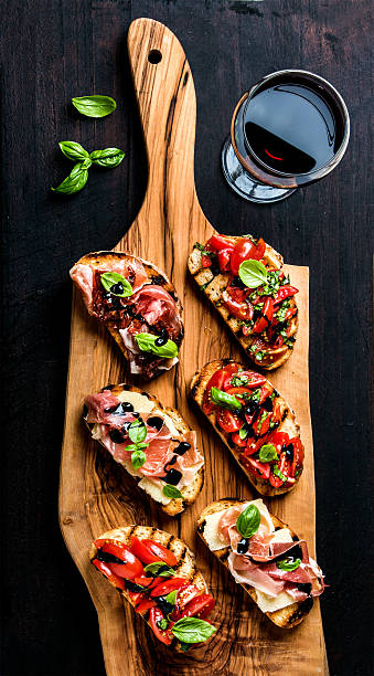 brushetta set and glass of red wine. small sandwiches with - baguette vinegar balsamic vinegar glazed imagens e fotografias de stock