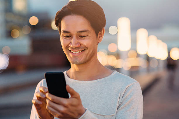 istock Young japanese man texting on the phone 577339206
