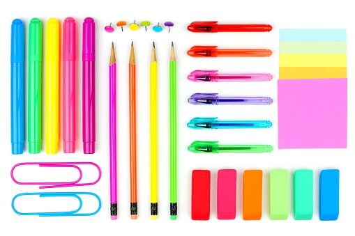 Colorful set of school supplies arranged as a flat lay on a white background