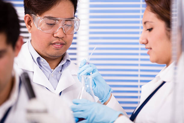 istock Multi-ethnic group of scientists in research laboratory. Science experiments. 577341230
