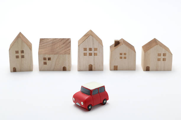 istock Miniature car and houses on white back ground. 577341932