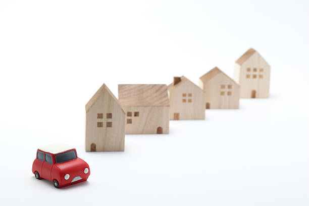 istock Miniature car and houses on white back ground. 577341942
