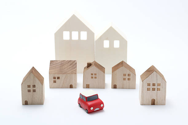 istock Miniature car and houses on white back ground. 577341964
