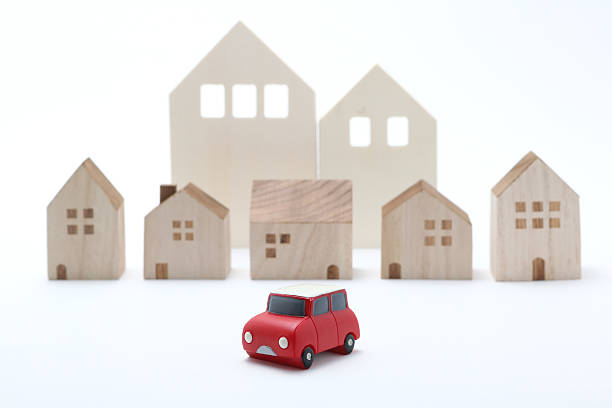istock Miniature car and houses on white back ground. 577341974