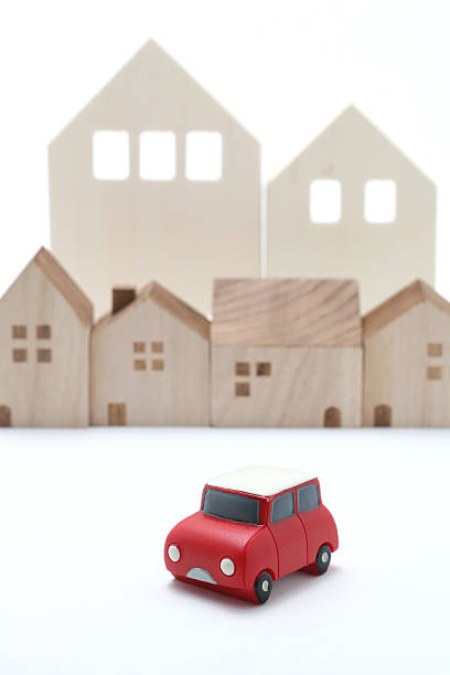 istock Miniature car and houses on white back ground. 577341996