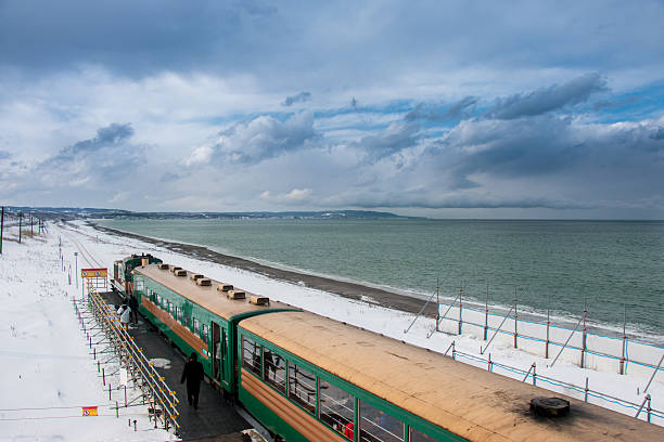 ryuho norokko Passenger train stop at the station along the beach, Top view. Abashiri, Hokkaido, Japan.