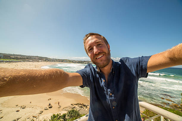 istock Young man takes a selfie portrait at Bondi beach, Australia 577343846