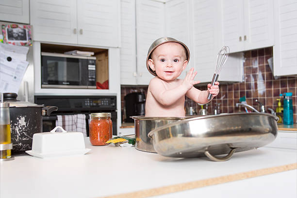istock adorable baby cooking in kitchen 577346434