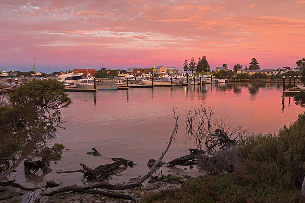Pink sky over Lake Butler boat marina during sunset, Robe stock photo