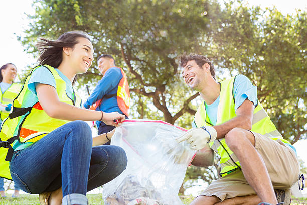 istock Laughing community service workers cleaning up local park 577348374