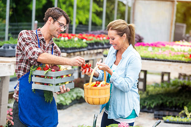 Organic local farmer giving veggies to shopper outside