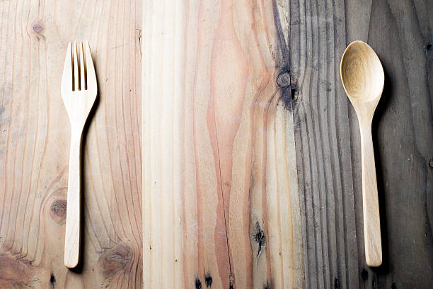 istock wooden spoon ,fork and bowl on wooden table 577348826
