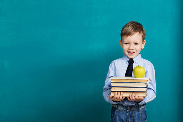 istock Cheerful smiling little kid against chalkboard 577349830