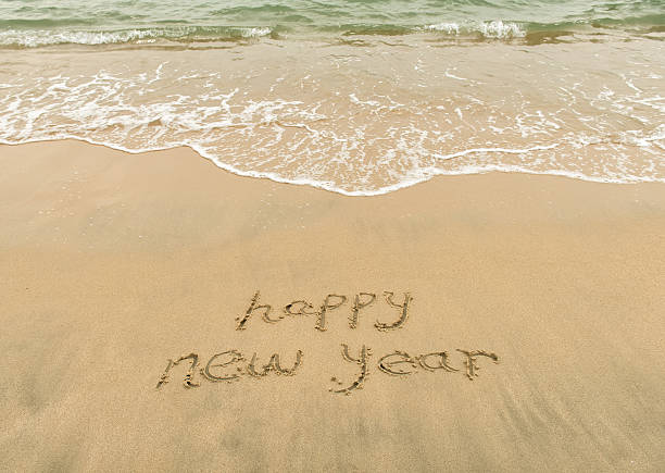 istock happy new year written in the sand 577350354