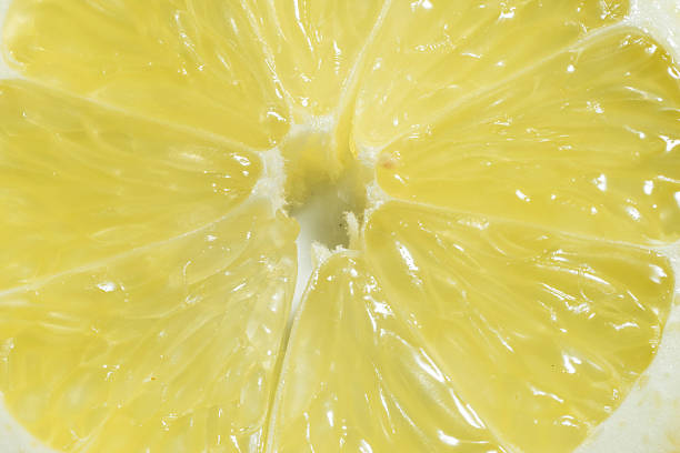 istock Close up of fresh lemon slice. Yellow fruit background 577350424
