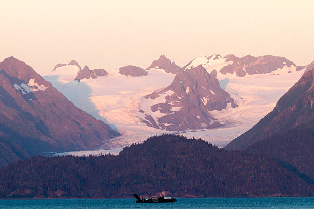 istock Ocean Boat and Snowy Mountains on Sunset 577615420