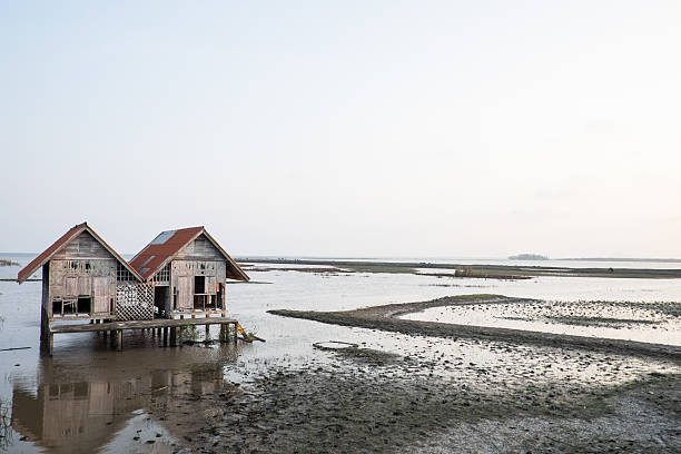 istock Twin abandoned houses on the arid lake 577615880