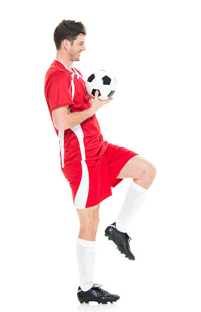 istock Cheerful soccer player holding ball 577617282