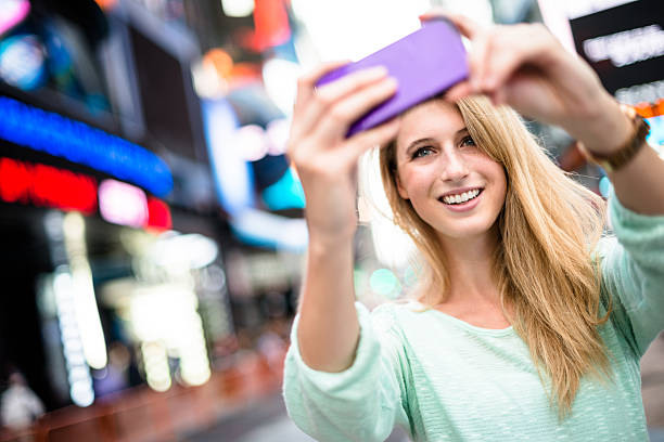 istock woman take a selfie on times square 577620594