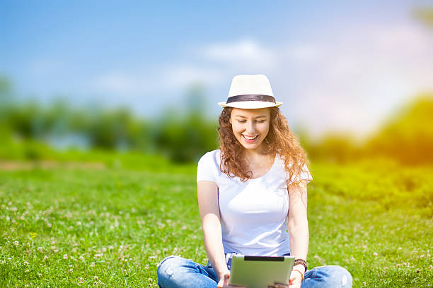 istock Young woman with tablet in summer 577621164