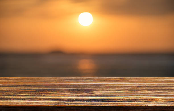 istock Empty wooden table with sea in sunset 577622268