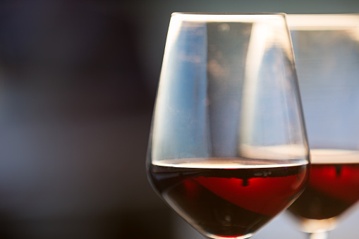 Two glasses with red wine, lens flare