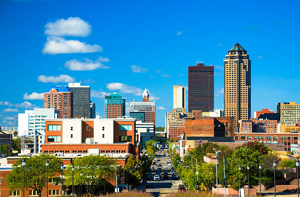 Des Moines Skyline View with Blue Sky and Clouds Downtown Des Moines skyline view with a blue s,y with clouds in the background. iowa stock pictures, royalty-free photos & images