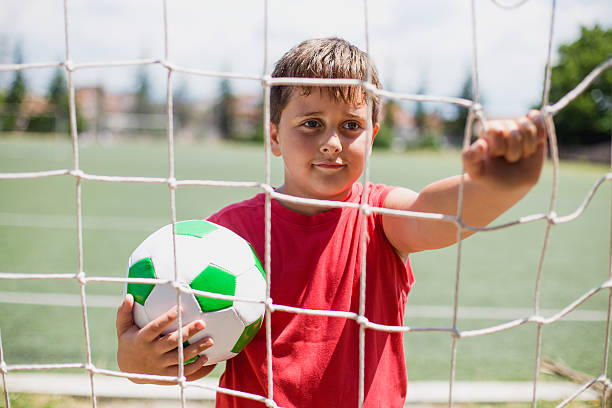 istock Boy with a football in hand 577624052