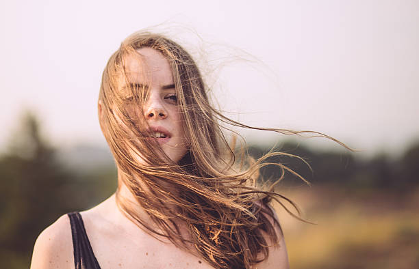 Close up portrait of happy smiling young blond girl outdoor