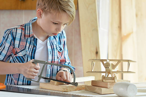 istock little boy  working with wood 577626378