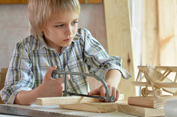 istock little boy  working with wood 577626586