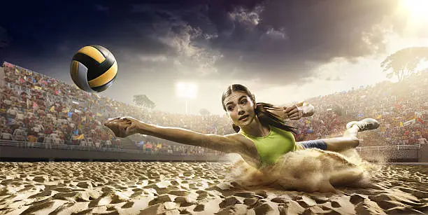 Beautiful female volleyball player performs an emotional game moment on the sand volleyball stadium with bleachers full of people. She is wearing an unbranded sports cloth.