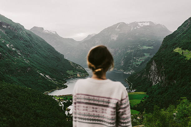 istock Woman looking at the Geirangerfjord 577628758