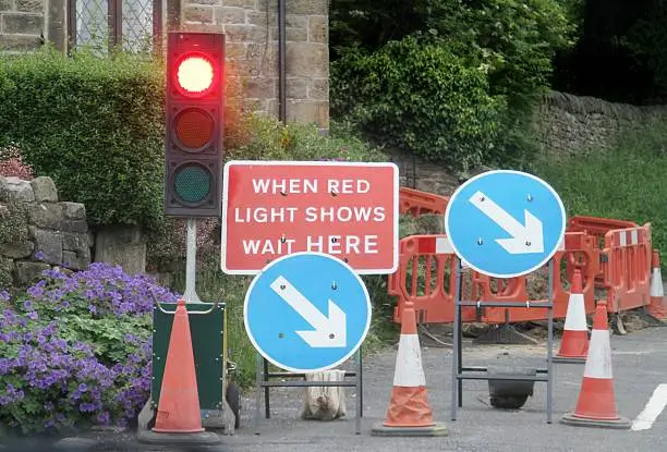 Roadworks with temporary traffic lights in rural village