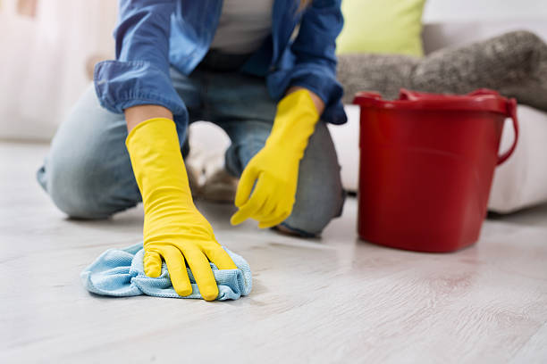 istock woman with gloves cleans the floor 577636330