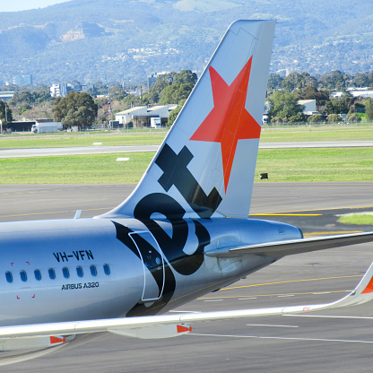 Adelaide, Australia - July 15, 2016: Jetstar is a part of the Qantas Airways Group. It operates both domestic and international routes from major Australian airports. Here is an Airbus A320 aircraft tail at Adelaide Airport. No people visible.