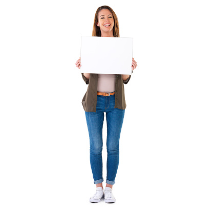 Studio shot of a young woman in casual clothes holding a blank field of white copyspace